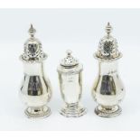A matched pair of Edwardian silver casters, pear shaped engraved with initial with domed pierced