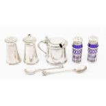 A group of silver condiments including a pair of tapering pepper and salt; tankard shaped mustard