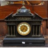 A good Victorian slate mantel/table clock. Case decorated with 6 reeded brass columns, cherubs,