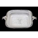 A George V silver butter dish holder, rectangular with scroll over handles above lower rail openwork
