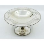 An Edwardian Neo-Classical silver tazza / fruit bowl, egg-and-dart border above engraved border of
