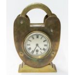 A brass desk clock in the shape of a padlock with a compass on the top. A very unusual clock. Solid,