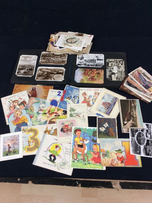 A collection of vintage postcards and greetings cards