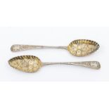 A matched pair of George III silver berry spoons, hallmarked by William Eley, London, 1796 & 1810,