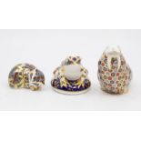 A collection of three Royal Crown Derby gold stopper paperweights, including a walrus, frog and