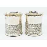 A pair of Edwardian silver jardinieres / small bottle holders, wavy cut rim above wavy gadroon lower