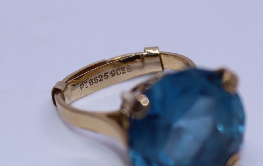 An 18ct. yellow gold blue topaz cocktail ring, four claw set round mixed cut brilliant blue topaz, - Image 3 of 3