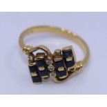 An 18ct yellow gold, diamond and sapphire cross-over ring, set eight square cut sapphires and