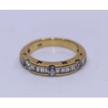 An 18ct. yellow gold and diamond half eternity ring, flush set three round brilliant cut diamonds