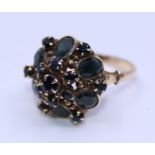 An 18ct. yellow gold and sapphire dress ring, the domed head set six oval mixed cut sapphires and