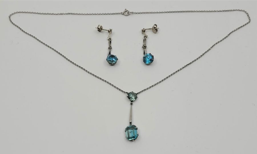An Art Deco style blue zircon drop pendant necklace together with a pair of drop earrings on