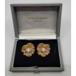 A pair of Van Cleef & Arpels 18ct. gold and diamond "Flower" earrings, the centre set cluster of