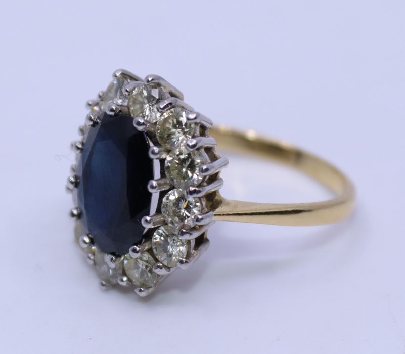 A precious yellow metal, sapphire and diamond oval dress ring, having galleried white metal head