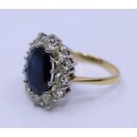 A precious yellow metal, sapphire and diamond oval dress ring, having galleried white metal head
