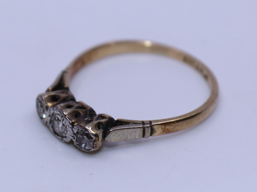 A 9ct. yellow gold and platinum three stone diamond ring,  flush set three graduated old-cut - Image 2 of 3