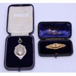 A gold brooch, weight: 2.4g together with a silver pendant, weight: 8.9g. (2)