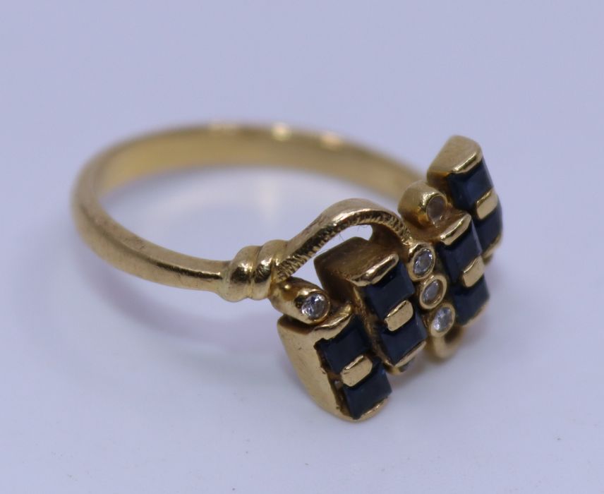 An 18ct yellow gold, diamond and sapphire cross-over ring, set eight square cut sapphires and - Image 2 of 3