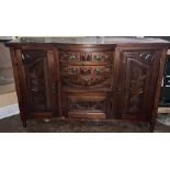 An early 20th century bow front mahogany sideboard, moulded top above two tier carved front