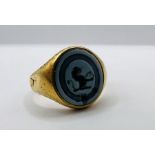 Hardstone intaglio set yellow metal ring, featuring lion rampant with ball. Tests as approx 22 ct