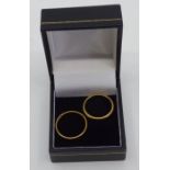 A pair of 22ct gold hallmarked band rings, size L 1/2 and P. Total weight 7.04 grams. (2)