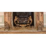 An ornate 19th century brass fire surround, prominently featuring two cherubs on prancing horses