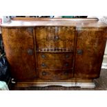 An Art Deco burr walnut sideboard, quarter gallery back on a inverted curved form, with a two panel