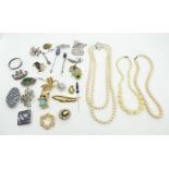 A selection of costume jewellery consisting of pearls, brooches and beads to include some silver. (