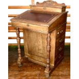 An Edwardian mahogany Davenport, circa 1910, scrolling carved quarter gallery back with an