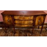 * A Sheraton influence mahogany and boxwood strung sideboard, serpentine shape oversailing top,