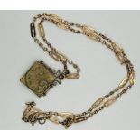 Unusual square shaped locket on razor blade style chain, containing antique photos of two young men.