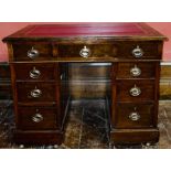 A George IV revival oak veneered kneehole pedestal writing desk, red leather inlay writing surface,