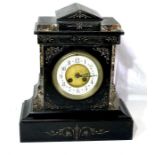 A late 19th Century ebonised marble and gilt strung mantel clock, 13cm dial with enamel chapter,