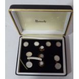 A cased set of gold coloured metal and mother of pearl gentleman's cufflinks and studs retailed by