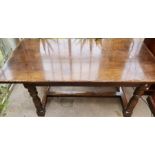 A 20th century oak refectory table, in a 17th century manner, single plank top, raised on a turned