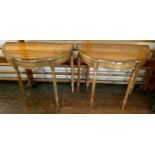 A pair of 20th century mahogany demi-lune console tables, in a Georgian style, shaped with a