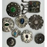 A large selection of handmade white metal and gemset brooches, a white metal gemset bracelet and