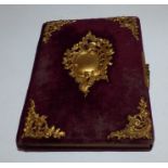 Victorian photograph album with gilt metal mounts on a velvet cover . no photographs