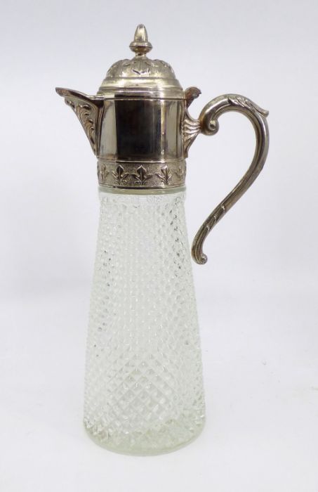 A glass claret jug with a silver plated handle and cover 31cm high