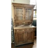 A Victorian pine chiffonier bookcase, moulded cornice above two panel glazed door bookcase,