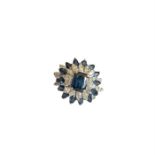 A cocktail ring of bluish green sapphires and marquise cut diamonds in white metal which tests as