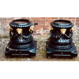 A pair of Regency cast iron urns, in the manner of George Bullock, ebonised and gilt in circular