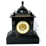 An early 20th Century ebonised marble and gilt mantel clock, foliage finial on a fretwork above gilt