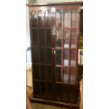 A Chinese hardwood glazed display cabinet, moulded outswept cornice above arch glazed inlay doors,
