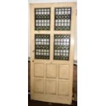 An Arts and Crafts painted oak and stained glass door, moulded panels. 211cm H x 92cm W