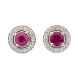 A pair of ruby and diamond 18ct white gold target studs, each comprising a round ruby claw set to