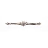 An Edwardian diamond bar brooch, the centre comprising a flower cluster of old cut diamonds, to a