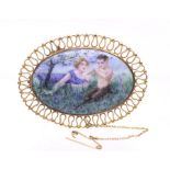 An Edwardian painted porcelain and 9ct gold brooch, comprising an oval plaque scene of a fawn and