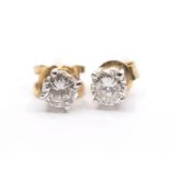 A pair of diamond and 18ct gold stud earrings, comprising claw set round brilliant cut diamonds with