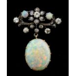 A Belle Époque opal and diamond gold and silver brooch, comprising a decorative floral diamond set