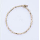 A diamond and 18ct yellow gold tennis bracelet, comprising round brilliant cut diamonds, channel set